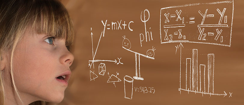  child looking in wonder of math equations