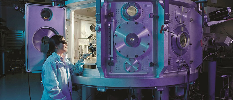  researcher standing by machine